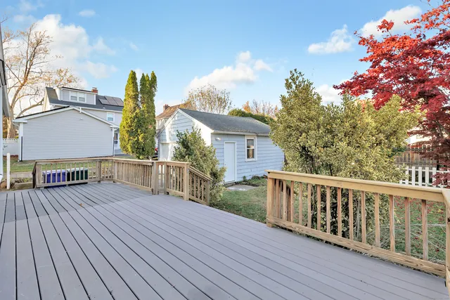 a view of empty room with wooden floor and fireplace