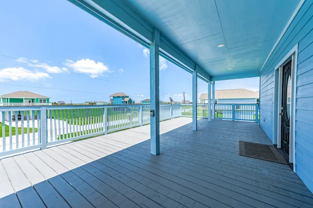 a large white kitchen with stainless steel appliances