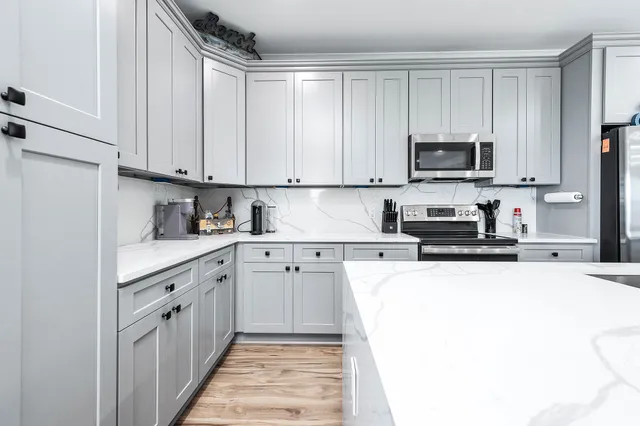 a kitchen with a sink stove and refrigerator