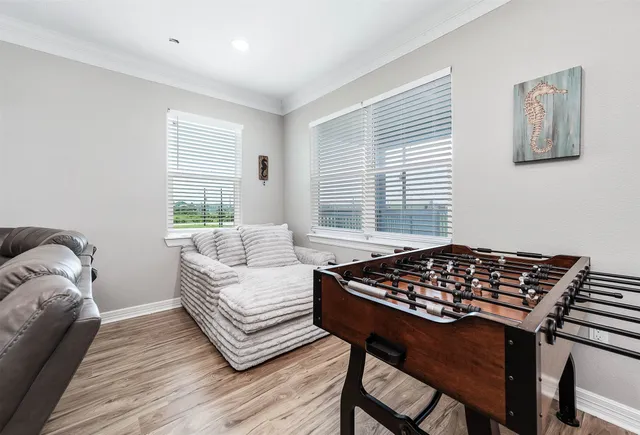 a living room with stainless steel appliances kitchen island granite countertop wooden floors and a view of kitchen
