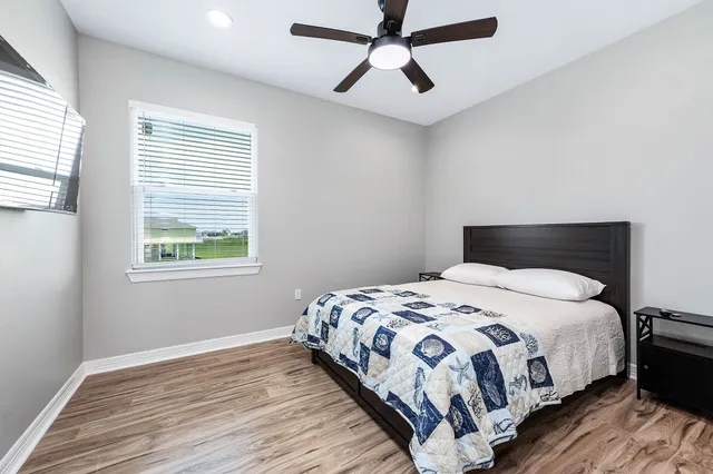 a bedroom with a bed and a window