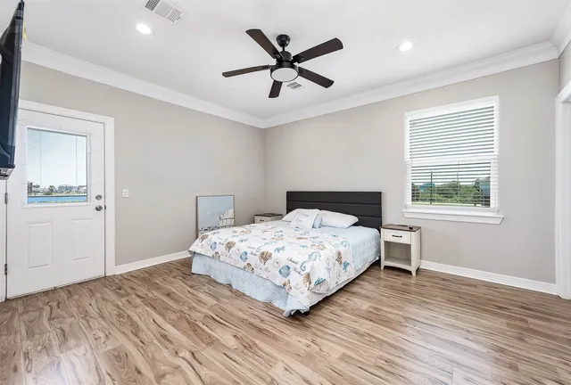 a bedroom with a large bed and a flat screen tv