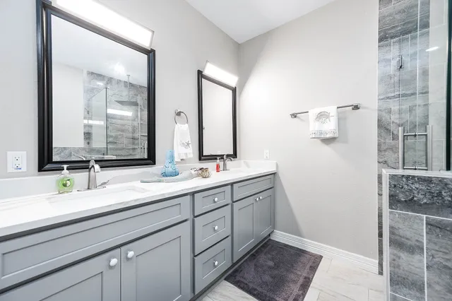 a bathroom with a shower and a sink