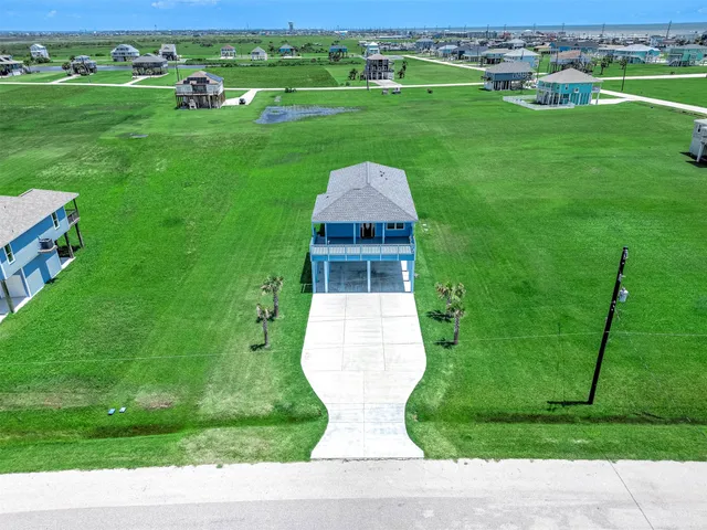 a view of a grassy field with grassy field and trees in the background