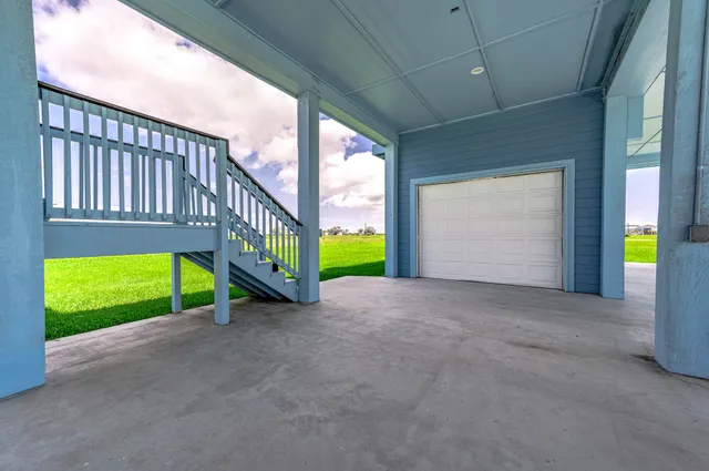 a view of an empty room with a window and brick walls