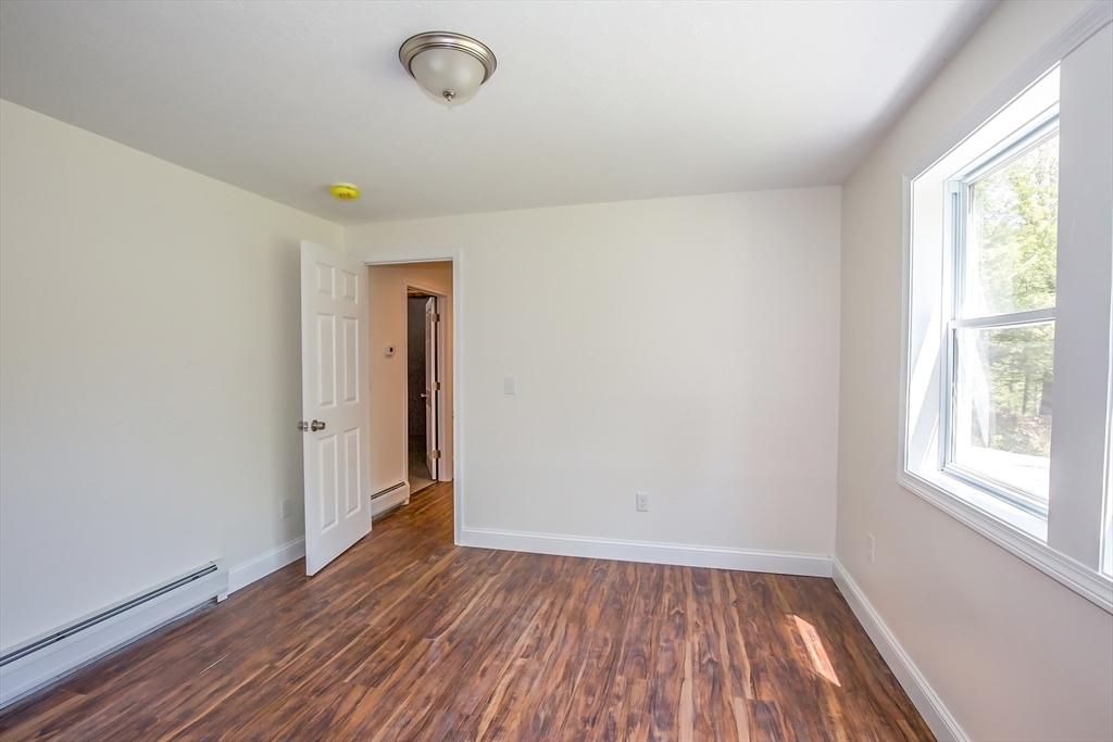 165 Sandisfield Road Sandisfield, MA 01255 - Photo 7 of 37 a view of room with window and wooden floor