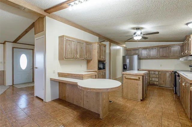 a kitchen with a sink stove and refrigerator
