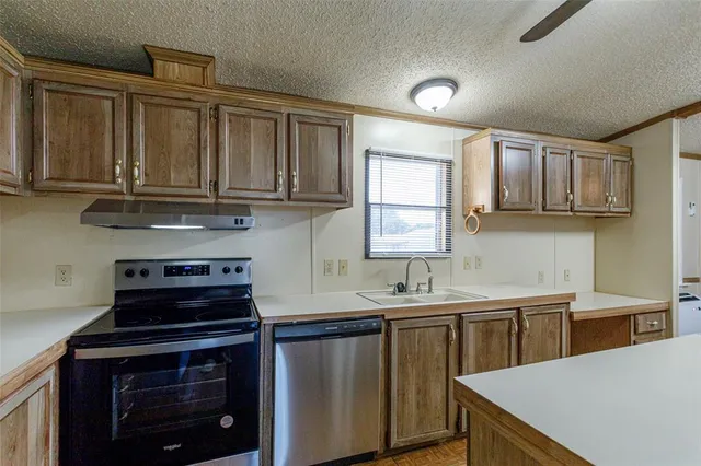 a kitchen with stainless steel appliances a stove sink and refrigerator