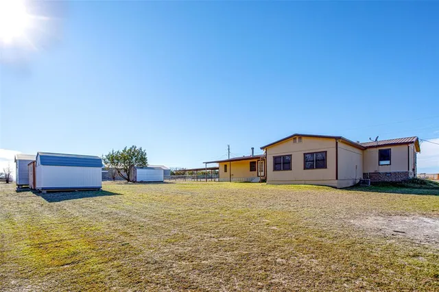 a view of a backyard of the house