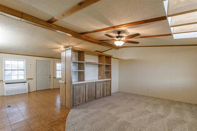 a view of a hallway to rooms and wooden floor