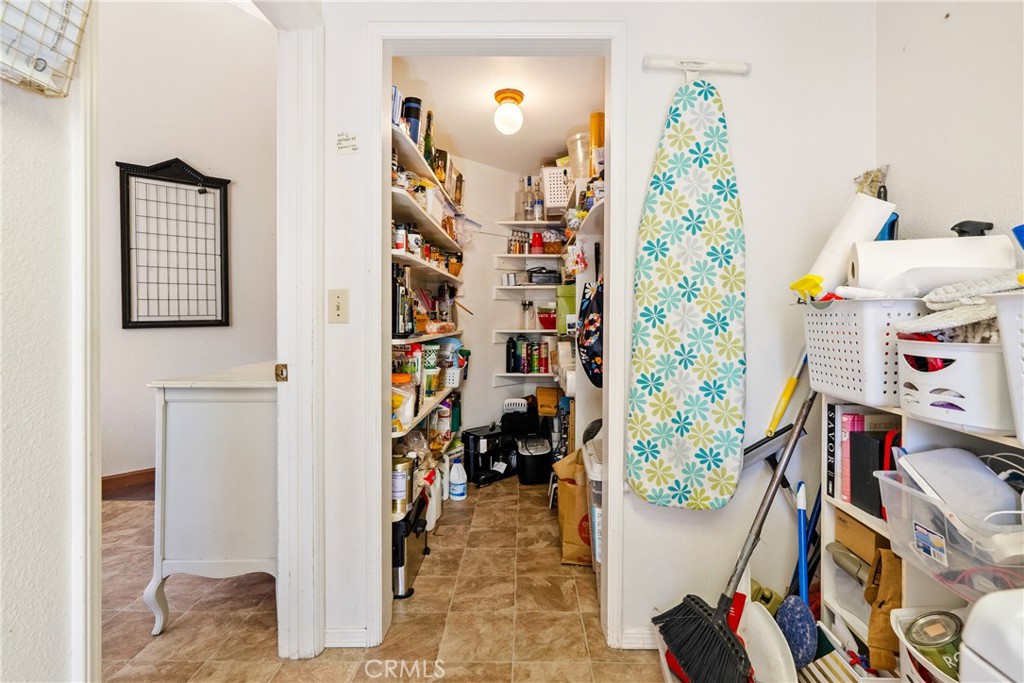 3880 Ardilla Road Atascadero, CA 93422 - Photo 14 of 60 The walk-in pantry has shelving and a light.