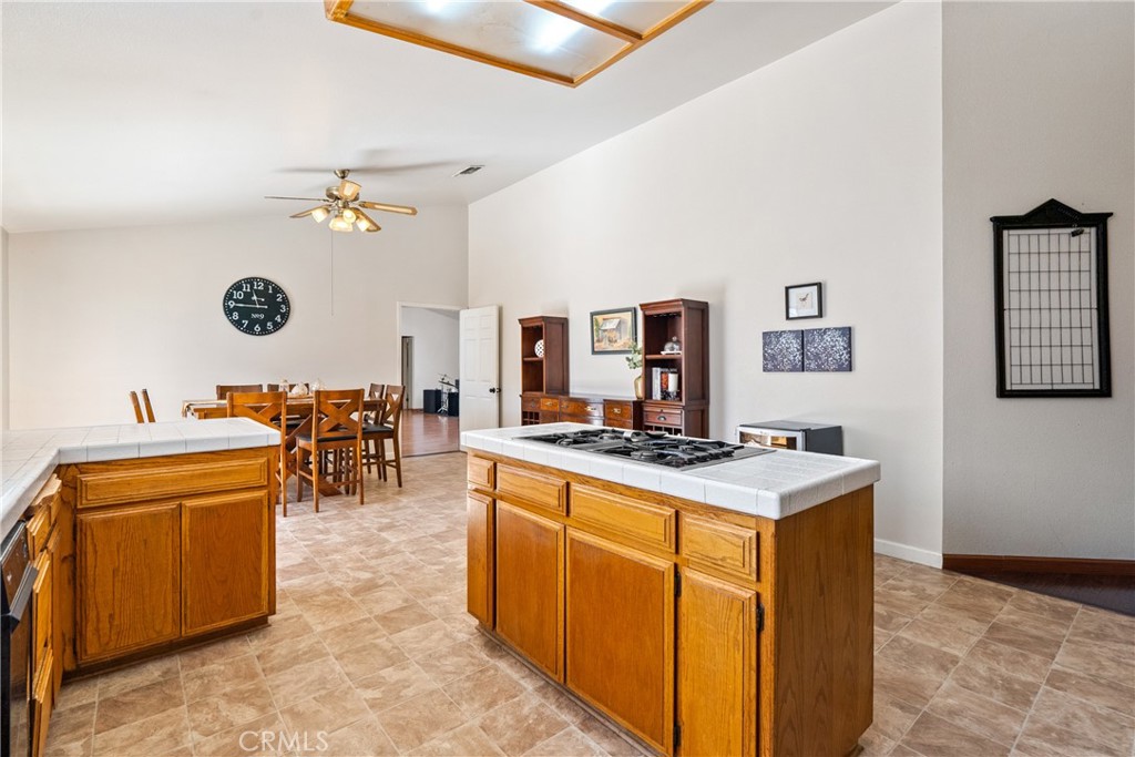 3880 Ardilla Road Atascadero, CA 93422 - Photo 16 of 60 a view of a kitchen with kitchen island stainless steel appliances a stove a sink dishwasher with a dining table and chair