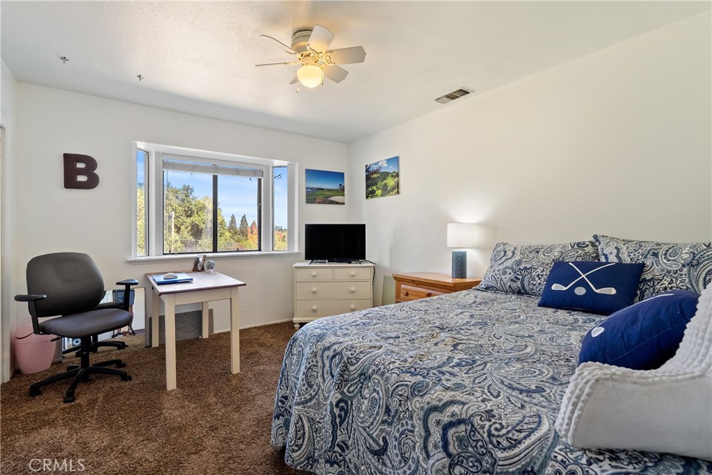 3880 Ardilla Road Atascadero, CA 93422 - Photo 23 of 60 a bedroom with a bed and a chair