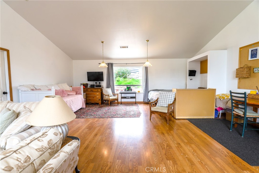 3880 Ardilla Road Atascadero, CA 93422 - Photo 23 of 66 The room features vaulted ceilings and laminate wood floors.
