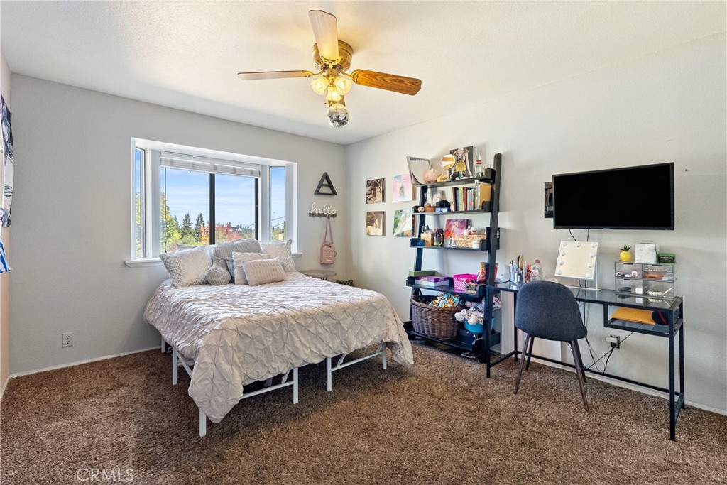 3880 Ardilla Road Atascadero, CA 93422 - Photo 25 of 60 a bedroom with a bed and a flat screen tv