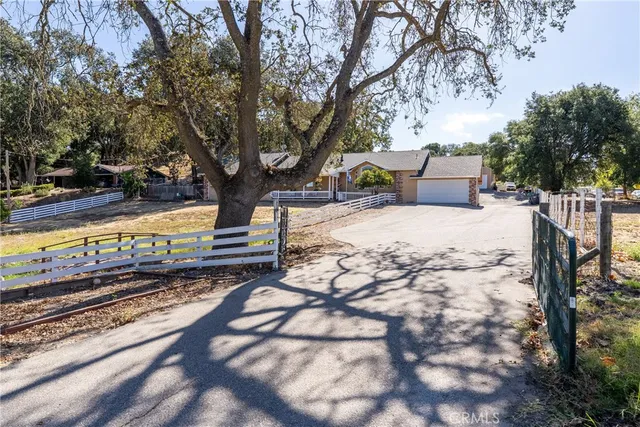 a view of a yard with wooden fence
