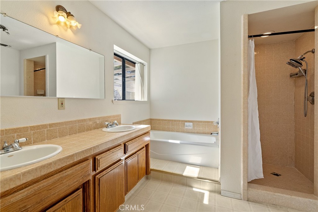 3880 Ardilla Road Atascadero, CA 93422 - Photo 34 of 66 The ensuite bathroom offers a soaking tub and walk-in shower.