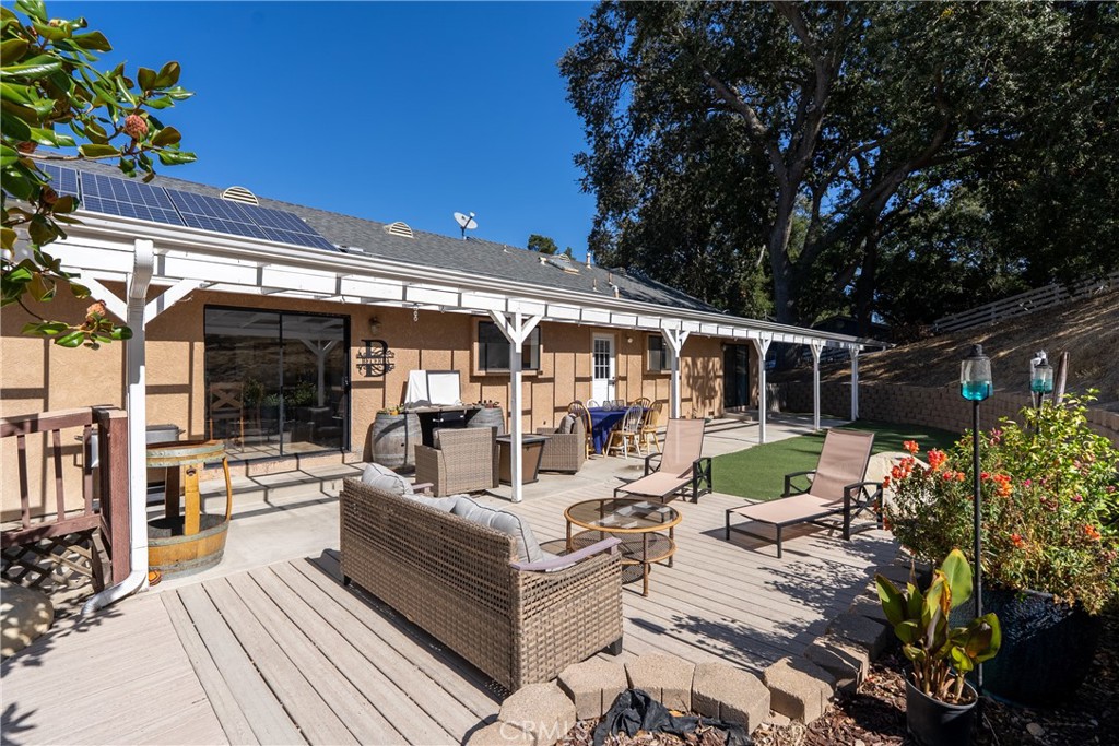 3880 Ardilla Road Atascadero, CA 93422 - Photo 38 of 60 a view of a patio with couches table and chairs and potted plants