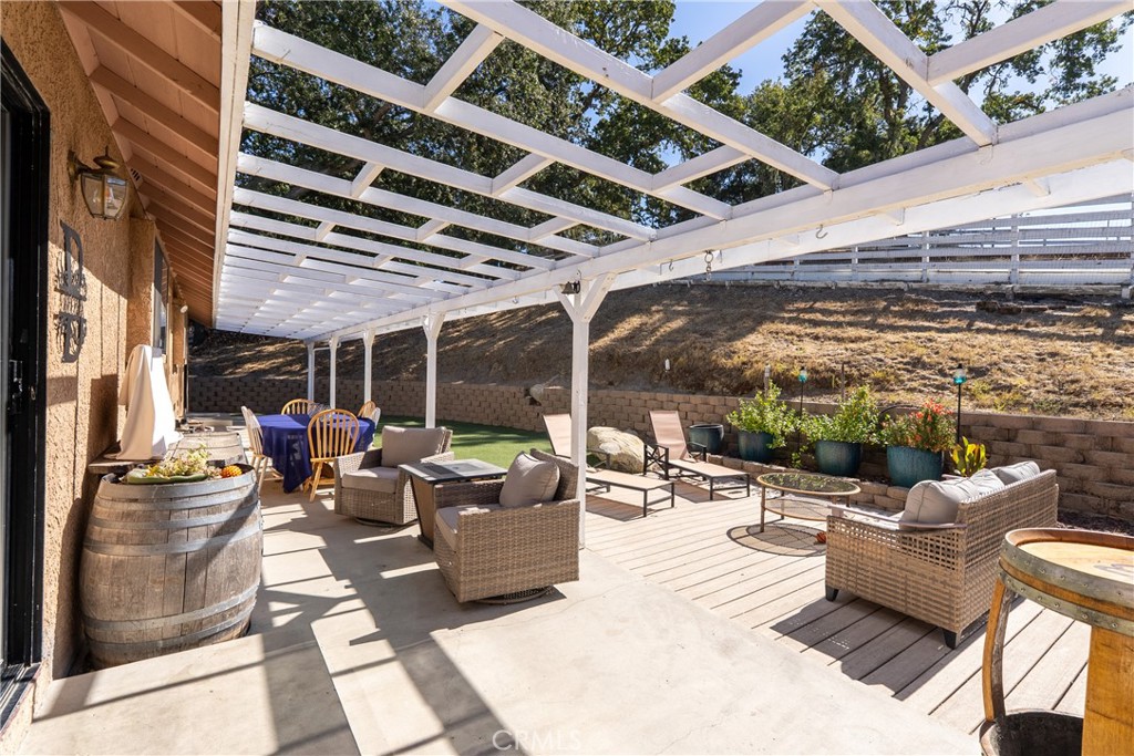 3880 Ardilla Road Atascadero, CA 93422 - Photo 40 of 60 a view of a patio with couches and chairs with wooden floor