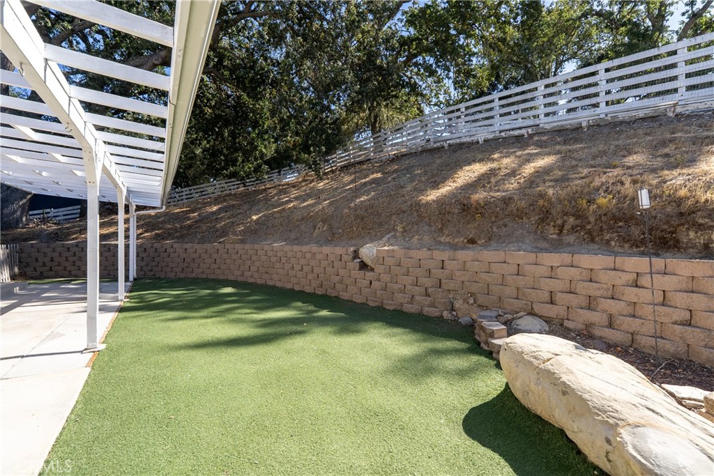 3880 Ardilla Road Atascadero, CA 93422 - Photo 50 of 66 There is a turf lawn area in the backyard that gives you the look of green lawn without the maintenance.