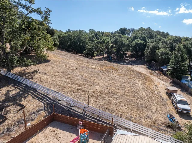 a front view of house with yard outdoor seating and barbeque oven