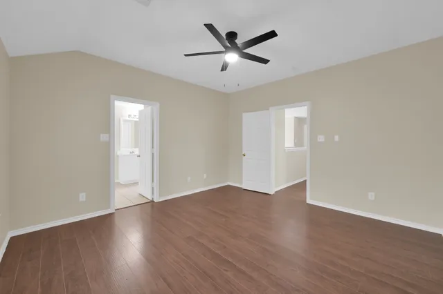 a view of an empty room and wooden floor
