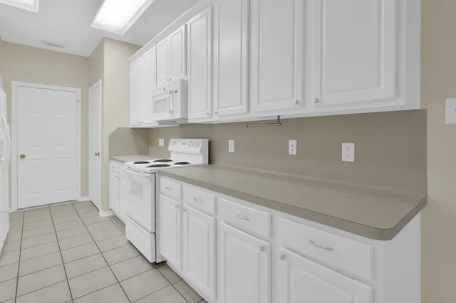 a kitchen with white cabinets