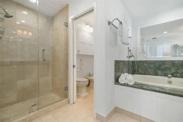 a bathroom with a granite countertop sink mirror and shower
