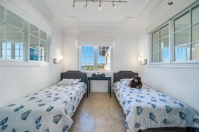 a bedroom with two beds and a window