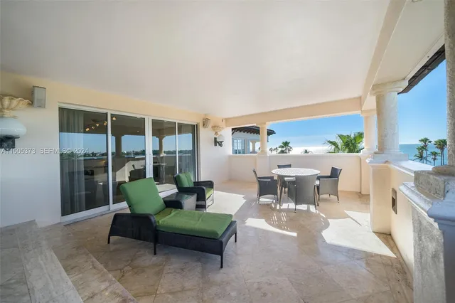 a living room with furniture and large windows