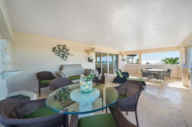 a dining room with furniture and a potted plant