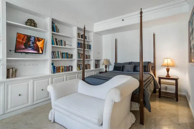 a bedroom with furniture and a book shelf