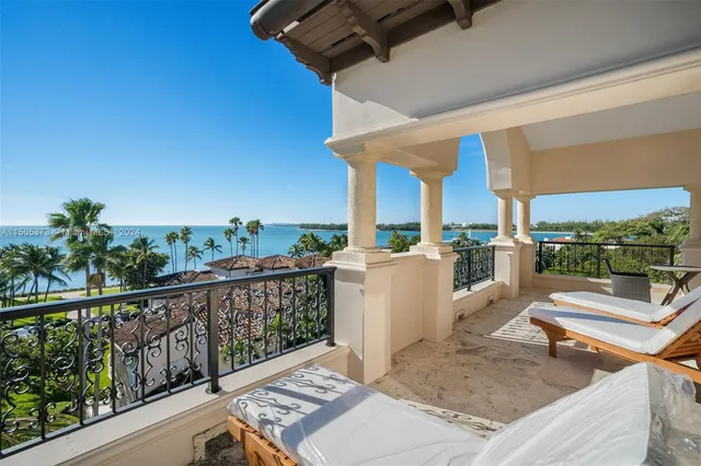 a view of a balcony with couches and wooden floor