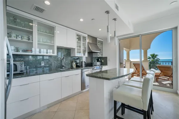 a kitchen with stainless steel appliances granite countertop a sink and cabinets