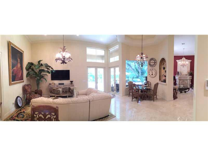 3700 Shady Ridge Road Fort Lauderdale, FL 33312 - Photo 7 of 17 a living room with furniture a chandelier and a flat screen tv