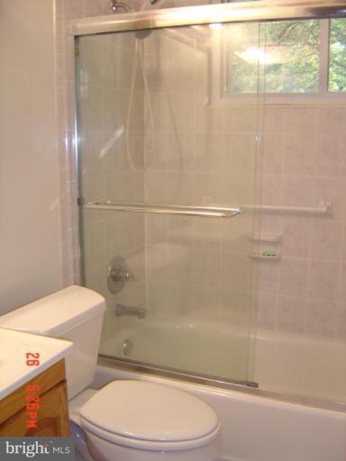 7205 Highland Street Springfield, VA 22150 - Photo 4 of 12 a white toilet sitting next to a bath tub