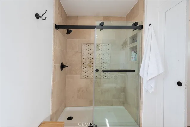 a bathroom with a glass shower door