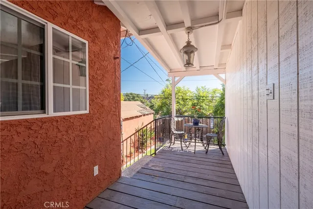 a view of a balcony with wooden floor