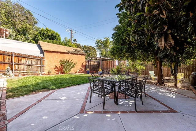 a view of a patio with table and chairs and potted plants