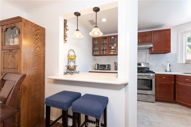 a kitchen with cabinets a sink and appliances