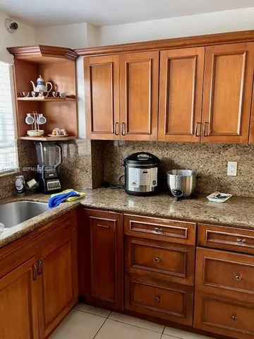 a kitchen with stainless steel appliances granite countertop a sink a stove and cabinets