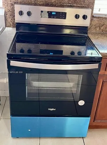a stove top oven sitting inside of a kitchen