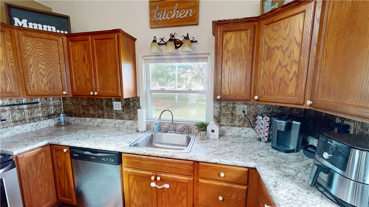 8 Chestnut Street Danville, IL 61832 - Photo 7 of 19 a kitchen with stainless steel appliances granite countertop a sink a refrigerator and a counter top space