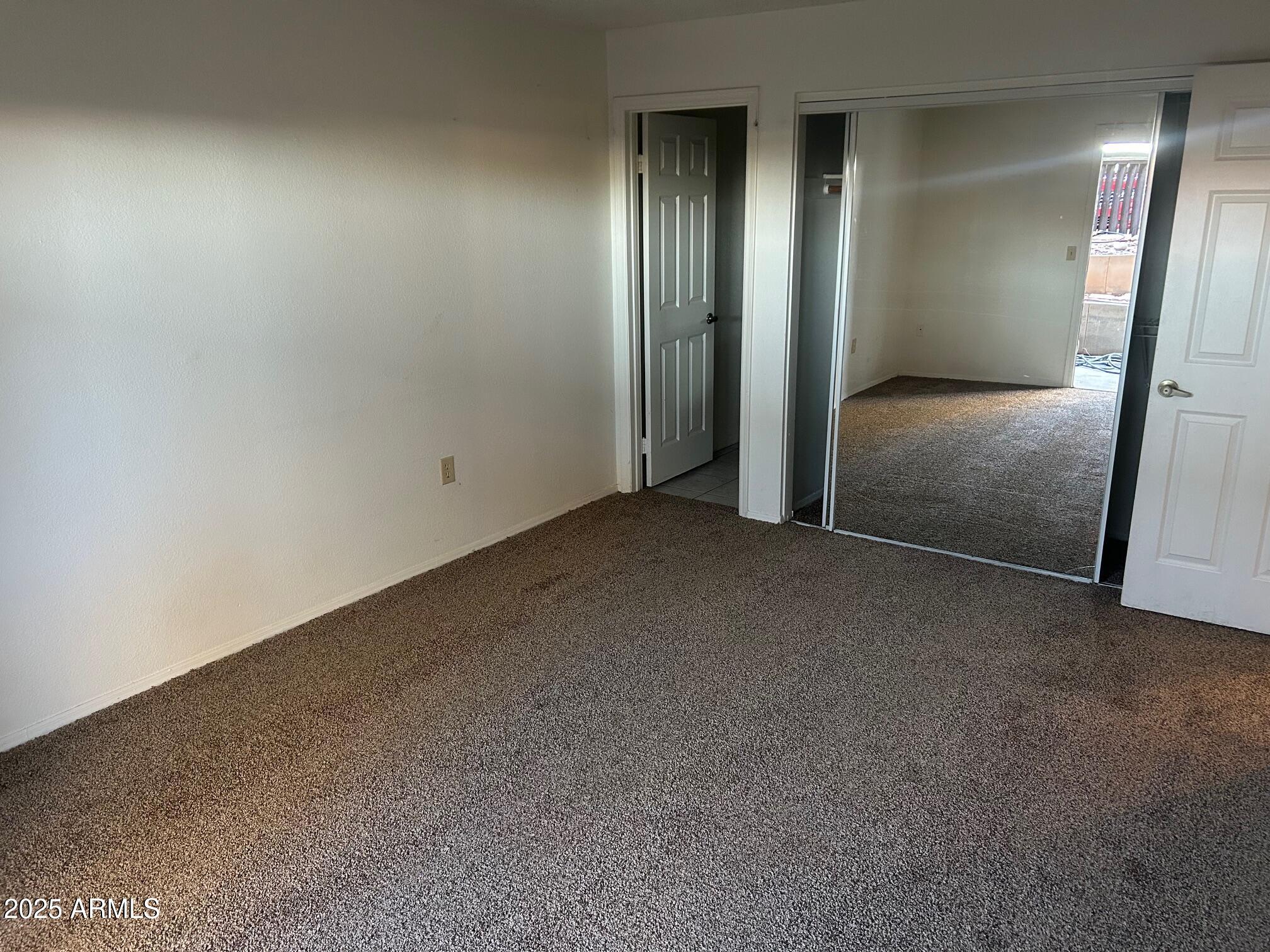 1645 West Baseline Road, Unit 1079 Mesa, AZ 85202 - Photo 11 of 19 an empty room with staircase and mirror
