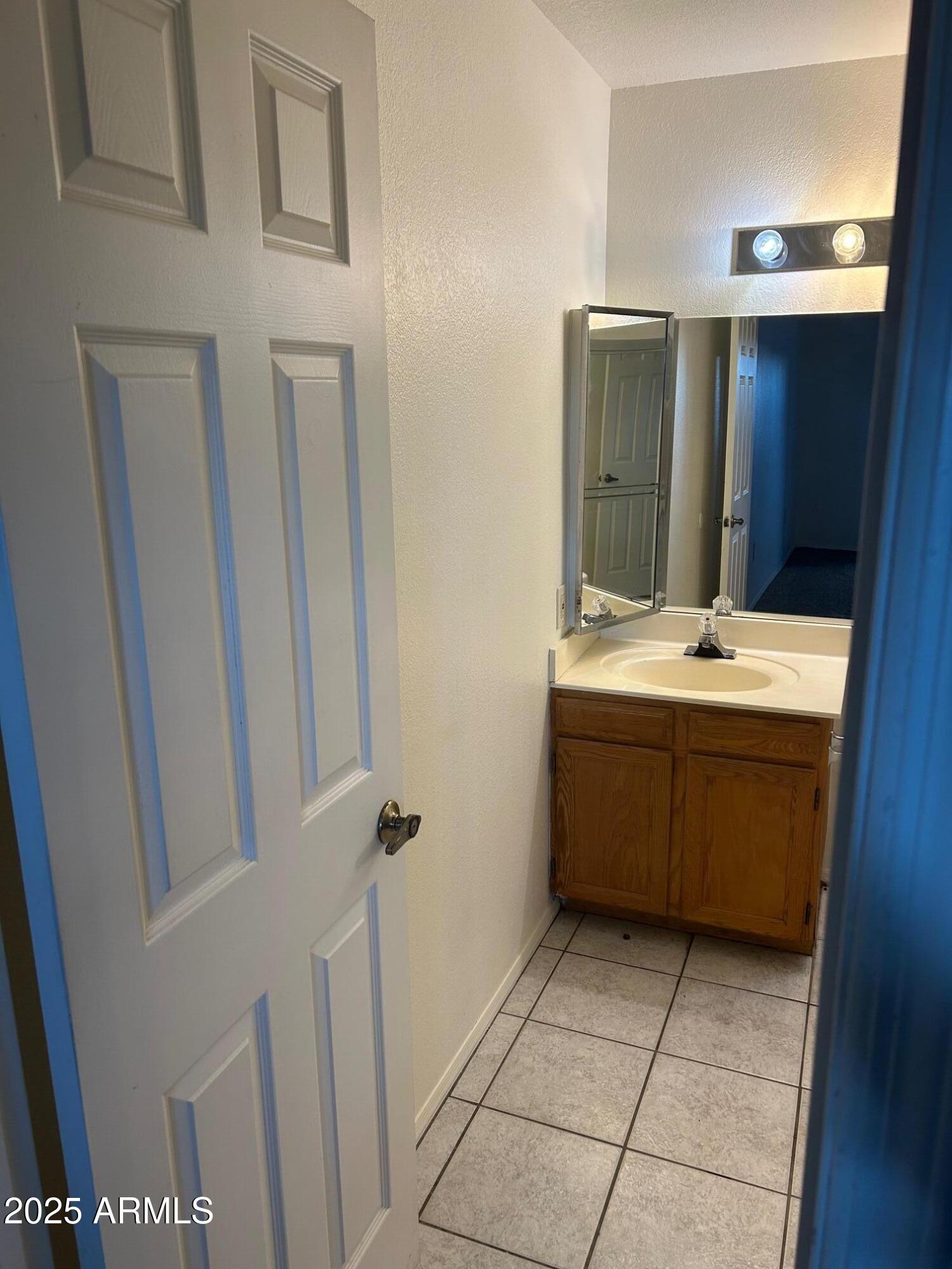 1645 West Baseline Road, Unit 1079 Mesa, AZ 85202 - Photo 12 of 19 a bathroom with a sink a toilet and mirror
