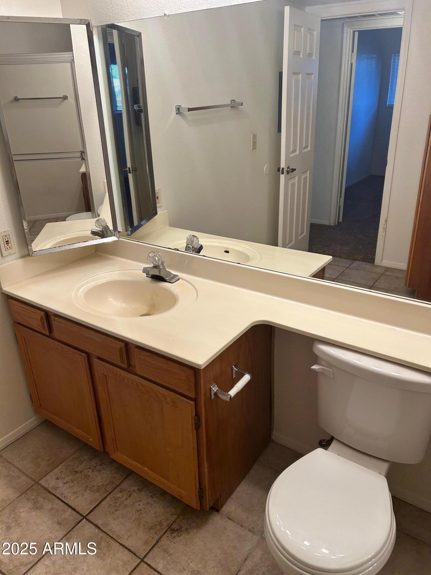 1645 West Baseline Road, Unit 1079 Mesa, AZ 85202 - Photo 13 of 19 a bathroom with a sink a toilet and mirror