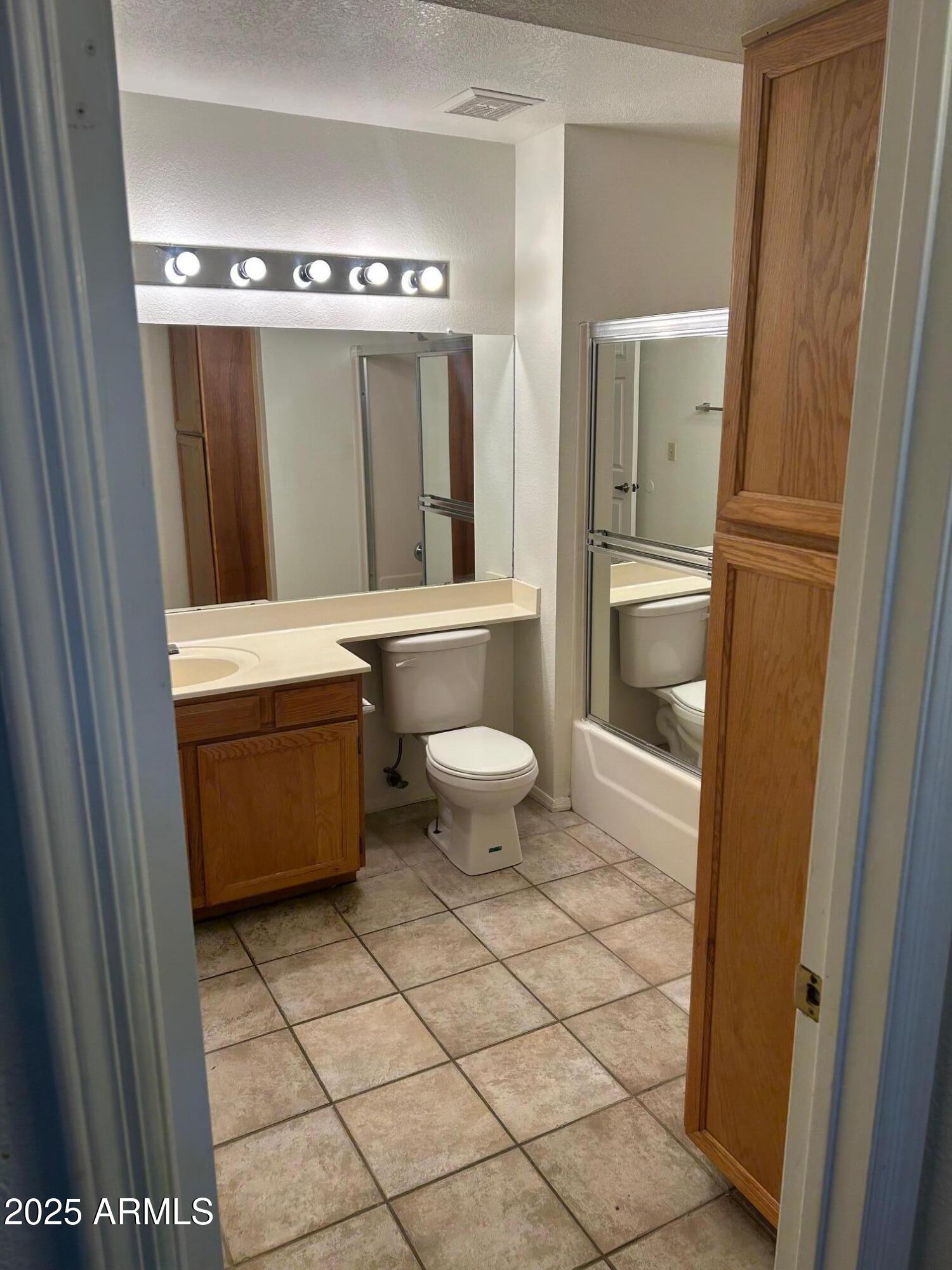 1645 West Baseline Road, Unit 1079 Mesa, AZ 85202 - Photo 18 of 19 a bathroom with a toilet a sink and a mirror