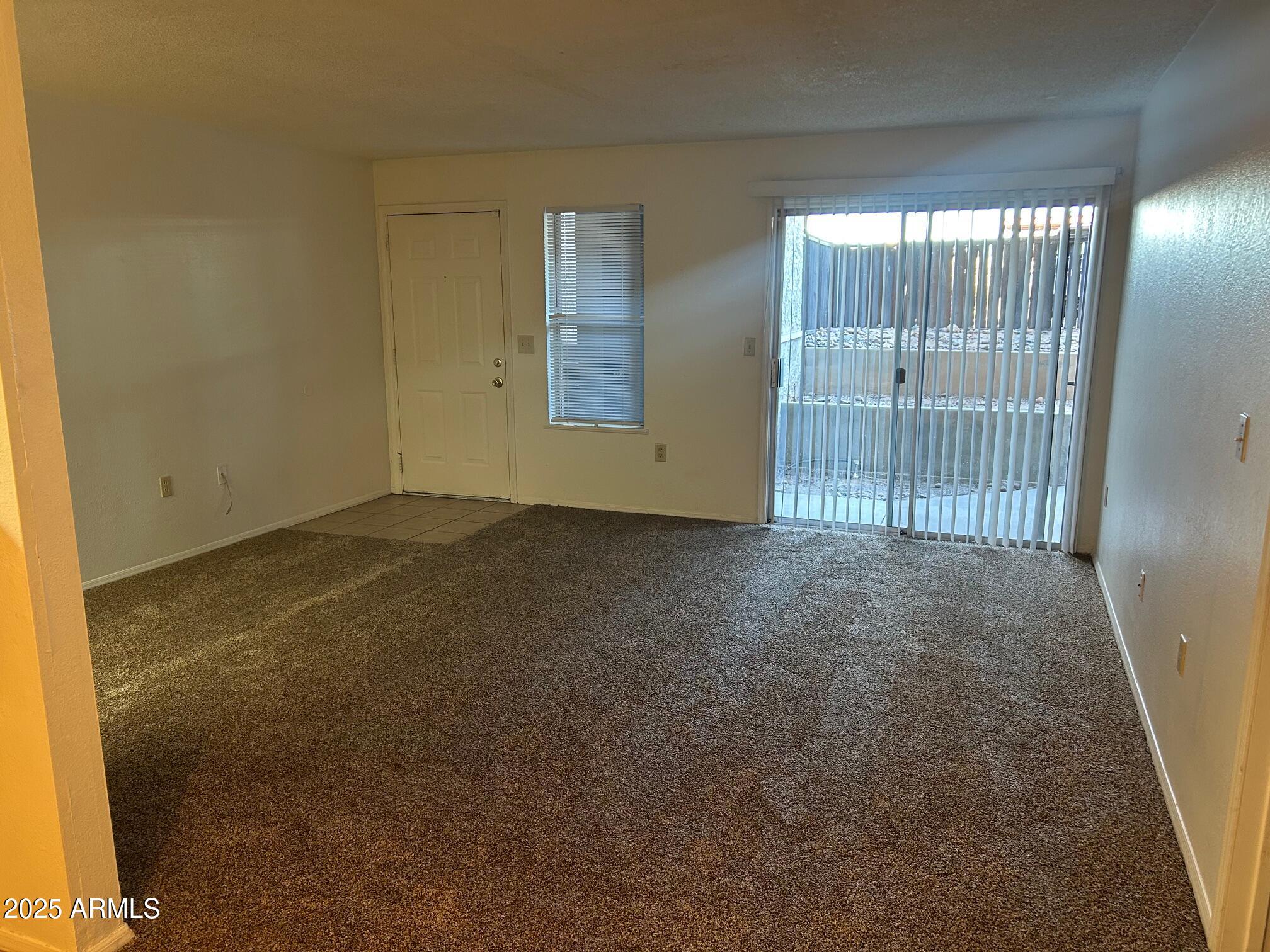 1645 West Baseline Road, Unit 1079 Mesa, AZ 85202 - Photo 6 of 19 a view of an empty room with windows