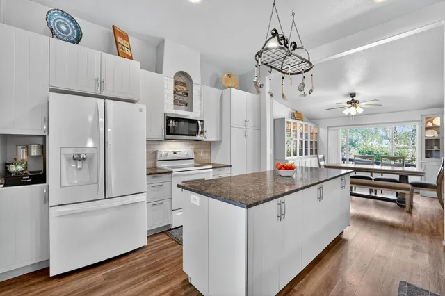 a view of a swimming pool with a patio and garden