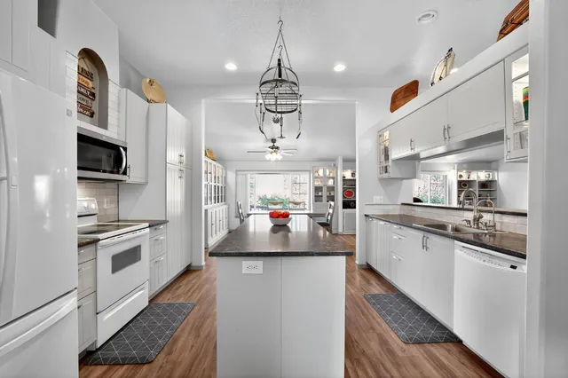 a bedroom with a large bed and a chandelier